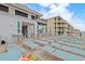 Relax by the pool in lounge chairs on the deck surrounded by tables and umbrellas at 5825 Catalina Dr. # 332, North Myrtle Beach, SC 29582