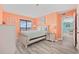 Bedroom with peach walls featuring a balcony and gray wood floors at 5905 S Kings Hwy. # 312-C, Myrtle Beach, SC 29575