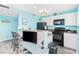 Bright kitchen featuring white cabinets, black appliances, and a functional breakfast bar area at 5905 S Kings Hwy. # 312-C, Myrtle Beach, SC 29575