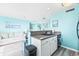Bright kitchen featuring white cabinets, stainless steel appliances, and beach-themed decor at 5905 S Kings Hwy. # 312-C, Myrtle Beach, SC 29575