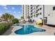 Beautiful outdoor pool with palm trees and condo building backdrop at 5905 S Kings Hwy. # 312-C, Myrtle Beach, SC 29575