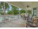Wooden deck with table, chairs, and rocking chairs, overlooking the neighborhood at 6001-1830A S Kings Highway, Myrtle Beach, SC 29575