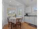 Small dining area with a round table and four chairs near kitchen at 6001-1830A S Kings Highway, Myrtle Beach, SC 29575
