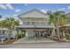 Elevated home with covered parking and palm trees at 6001-1830A S Kings Highway, Myrtle Beach, SC 29575