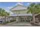 Front view of an elevated beach house with a porch at 6001-1830A S Kings Highway, Myrtle Beach, SC 29575