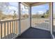 View from screened porch with white railing overlooking green trees at 627 Waterway Village Dr. # 8-I, Myrtle Beach, SC 29579