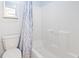 Clean bathroom showcasing a toilet, tub, and shower with a blue and white patterned curtain at 627 Waterway Village Dr. # 8-I, Myrtle Beach, SC 29579