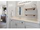 Bathroom with white vanity, shelves, mirror, bright lighting, and a doorway leading to another room at 627 Waterway Village Dr. # 8-I, Myrtle Beach, SC 29579