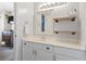 Stylish bathroom features white cabinetry, a framed mirror, and open wood shelving at 627 Waterway Village Dr. # 8-I, Myrtle Beach, SC 29579