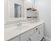Bright bathroom featuring a white vanity, framed mirror, and open wooden shelving for storage at 627 Waterway Village Dr. # 8-I, Myrtle Beach, SC 29579