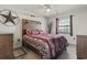 Comfortable bedroom featuring a decorative headboard, ceiling fan, and window at 627 Waterway Village Dr. # 8-I, Myrtle Beach, SC 29579