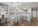 Cozy kitchen nook features white table set, pendant light, breakfast bar and wood grain floors at 627 Waterway Village Dr. # 8-I, Myrtle Beach, SC 29579