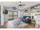 Bright living room featuring a cozy couch, balcony access, and stylish decor with wood flooring at 627 Waterway Village Dr. # 8-I, Myrtle Beach, SC 29579