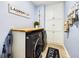 Well-organized laundry room featuring a wood countertop, modern washer and dryer, and ample storage cabinets at 656 Hickman St., Surfside Beach, SC 29575