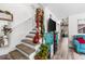 A brightly decorated hallway featuring carpeted stairs and a blue couch at 6702 Jefferson Pl. # B6, Myrtle Beach, SC 29572