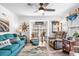 Cozy living room featuring a comfortable teal sofa, decorative pillows, and a ceiling fan at 6702 Jefferson Pl. # B6, Myrtle Beach, SC 29572