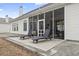 Back patio with lounge chairs and a view into the screened-in sunroom of the home at 720 Dove Haven Ln., Myrtle Beach, SC 29579