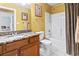 Bright bathroom with granite countertop, wooden cabinet, shower-tub, and charming decorative accents at 720 Dove Haven Ln., Myrtle Beach, SC 29579