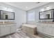 Bathroom with white cabinets, double sinks, tile flooring, a soaking tub, and a glass block window at 720 Dove Haven Ln., Myrtle Beach, SC 29579