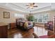 Primary bedroom with wood floors, tray ceiling, ceiling fan, and windows for plenty of natural light at 720 Dove Haven Ln., Myrtle Beach, SC 29579