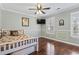 Bedroom with hardwood floors, a ceiling fan, a window, and a closet for storage at 720 Dove Haven Ln., Myrtle Beach, SC 29579