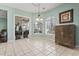 Bright dining area with tiled floors, modern light fixture, and large sliding glass doors at 720 Dove Haven Ln., Myrtle Beach, SC 29579