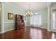 Classic dining room featuring hardwood floors, chandelier, large windows, and fresh paint at 720 Dove Haven Ln., Myrtle Beach, SC 29579