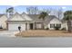 Charming single-story home with a brick facade, a two-car garage, and a well-manicured lawn at 720 Dove Haven Ln., Myrtle Beach, SC 29579