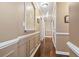 Hallway with dark wood flooring, decorative wall panels, and recessed lighting at 720 Dove Haven Ln., Myrtle Beach, SC 29579