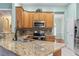 Close-up of the kitchen showcasing granite countertops, stainless steel appliances, and custom cabinetry at 720 Dove Haven Ln., Myrtle Beach, SC 29579