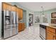 Open kitchen featuring stainless steel appliances, tile floors, island, light countertops, and ample cabinet space at 720 Dove Haven Ln., Myrtle Beach, SC 29579