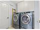 Laundry room featuring modern appliances and white cabinets for ample storage at 720 Dove Haven Ln., Myrtle Beach, SC 29579