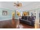Open-concept living area with hardwood floors, a comfortable couch, and seamless transition to the kitchen at 720 Dove Haven Ln., Myrtle Beach, SC 29579