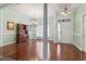 Elegant living room features hardwood floors, fresh paint, chandelier and entry way with decorative column at 720 Dove Haven Ln., Myrtle Beach, SC 29579