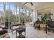 Charming sunroom filled with wicker furniture and offering peaceful views of the wooded backyard at 720 Dove Haven Ln., Myrtle Beach, SC 29579