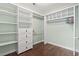 Walk-in closet with custom shelving, drawer space, wood floors, and a hanging rod at 720 Dove Haven Ln., Myrtle Beach, SC 29579