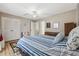 Well-lit bedroom features natural light, a ceiling fan, and tasteful decor with modern carpet and neutral color tones at 831 Villa Dr. # 831, North Myrtle Beach, SC 29582