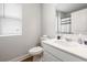 Bathroom with white vanity, toilet, and a shower with a striped curtain and window at 1052 Kinness Dr., Conway, SC 29527