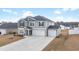 Charming two-story home with gray siding, black shutters, and a three-car garage at 1052 Kinness Dr., Conway, SC 29527