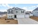 Charming two-story home with gray siding, black shutters, and a three-car garage at 1052 Kinness Dr., Conway, SC 29527