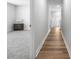 Hallway featuring modern flooring leading into a spacious room with a gray carpet at 1052 Kinness Dr., Conway, SC 29527