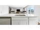 Kitchen island with a stainless steel sink and white cabinetry, opening into the living spaces at 1052 Kinness Dr., Conway, SC 29527