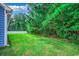 Lush backyard featuring a green lawn, mature trees, and a white fence at 106 Riverwatch Dr., Conway, SC 29527