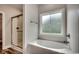 A bathroom featuring a shower with glass door and bathtub with a large window at 106 Riverwatch Dr., Conway, SC 29527