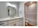 Modern bathroom vanity with a large mirror, bright lighting, and tub-shower combo at 106 Riverwatch Dr., Conway, SC 29527