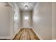 Inviting hallway featuring beautiful hardwood floors and crisp, white trim leading to the front door at 106 Riverwatch Dr., Conway, SC 29527