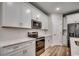 Modern kitchen with stainless steel appliances, white cabinets, and white subway tile backsplash at 106 Riverwatch Dr., Conway, SC 29527