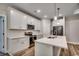 Modern kitchen with stainless steel appliances, white cabinets, quartz countertops, and hardwood floors at 106 Riverwatch Dr., Conway, SC 29527