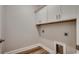 Bright laundry room featuring white cabinetry and wood-look flooring at 106 Riverwatch Dr., Conway, SC 29527