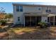 Exterior of home, featuring a sunroom and a small backyard with dry grass at 1061 Pinwheel Loop # 1061, Myrtle Beach, SC 29577